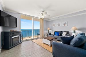 ein Wohnzimmer mit einem Sofa, einem Kamin und einem TV in der Unterkunft Tidewater Beach Resort 2505 - Sea Gem in Panama City Beach