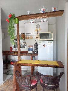 a kitchen with a wooden table and two chairs at Casa simples em Diamantina in Diamantina