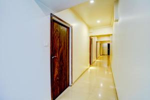 a hallway with a wooden door and a corridor at FabHotel Kwality Inn in Mumbai
