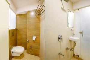 a bathroom with a toilet and a sink and a shower at FabHotel Kwality Inn in Mumbai
