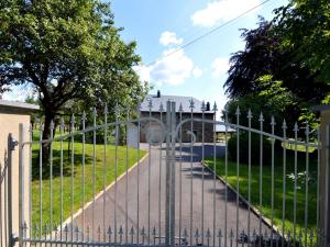 a gate in front of a yard with grass at Beautiful holiday home near Vielsalm with rural view in Vielsalm