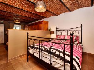 a bedroom with a black bed in a brick wall at Beautiful holiday home near Vielsalm with rural view in Vielsalm