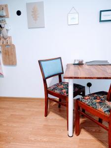a table with two chairs and a wooden table with a table and a table at Apartment in Center in Kraków
