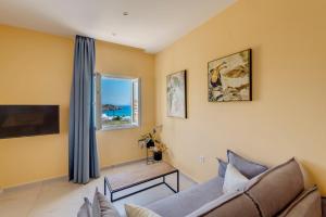 a living room with a couch and a window at Armenaki in Azolimnos Syros