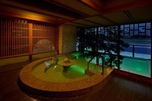 a large room with a pool in the middle of a building at Juhachiro in Gifu +34 photos