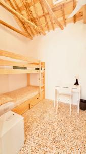 a room with two bunk beds and a desk at Alojamiento Nevada in La Zubia