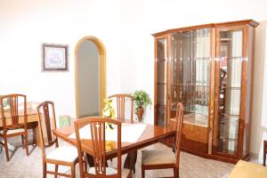 a dining room with a wooden table and chairs at Casa Vacanze Galatone delle Arance in Galatone