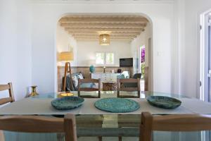 a dining room with a glass table and chairs at Villa Lydia in Faro