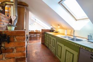 a kitchen with a sink and a brick wall at Horse Farm Holiday Pr' Kolenc in Zgornje Gorje