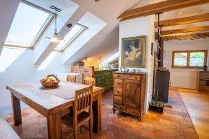 a kitchen with a wooden table and a dining room at Horse Farm Holiday Pr' Kolenc in Zgornje Gorje +32 photos