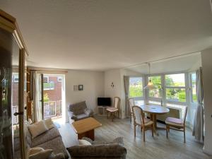 a living room with a table and a couch at Marina in Schönberger Strand