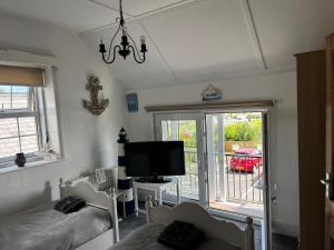 a bedroom with two beds and a flat screen tv at The View in Tynemouth
