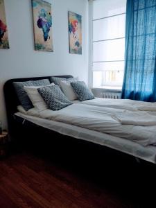 a large bed in a bedroom with a window at Apartment in Center in Kraków