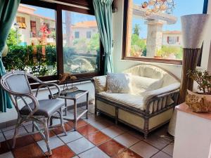 a living room with two chairs and a couch at Hotel Elba in Marina di Campo