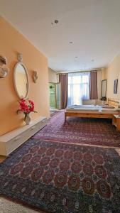 a large room with a bed and a mirror at Kamil Apartments, Lux S, 131m2 in Karlovy Vary