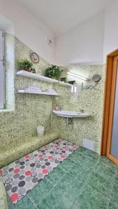 a room with a tile wall with a rug on the floor at Kamil Apartments, Lux S, 131m2 in Karlovy Vary