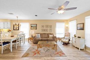 a living room with a couch and a table at 21720 Front Beach Rd - Pelican's Nest in Panama City