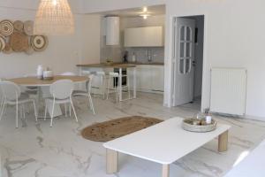 a kitchen and living room with a table and chairs at Nonta's Luxury Home in Megalochori