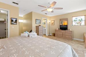 a bedroom with a bed and a ceiling fan at 21720 Front Beach Rd - Pelican's Nest in Panama City