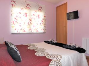 a bedroom with a bed with black and white pillows at Casa Armonia in Avila