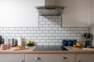 a kitchen with a counter top with food on it at Angel Cottage - 5 mins drive to Alton Towers! in Alton