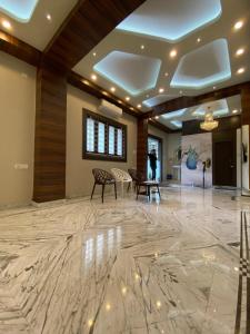 a lobby with a marble floor and wooden ceilings at Krishna Kunja " A Quiet & Peaceful Stay " in Kolkata