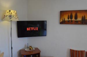 a flat screen tv on a wall in a room at Remvi Apartments in Skopelos Town