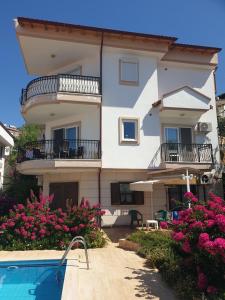 a house with a swimming pool in front of it at Manolyam suit havuzlu 2+1 in Kaş