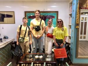 a group of people posing for a picture in a room at Mangalmayee Heritage Home in Jaipur