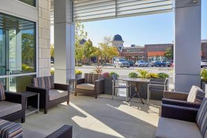 a patio with chairs and a table on a building at TownePlace Suites by Marriott Columbus North - OSU in Columbus