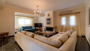 a living room with a couch and a table at Villa Afrato in Kefallonia