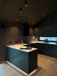 a kitchen with a island in the middle of it at Sogndal Chalet in Sogndal