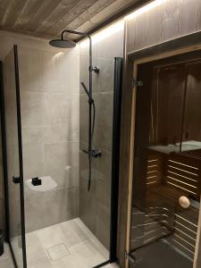 a shower with a glass door in a bathroom at Sogndal Chalet in Sogndal