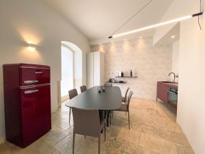 a kitchen and dining room with a table and chairs at Terrazzini Cibele in Andria
