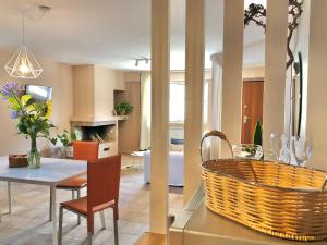 a dining room and living room with a table and chairs at Blue Apricot Apartment con Jacuzzi in Montesilvano
