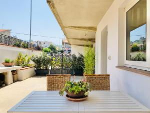 a patio with a table and chairs on a balcony at Blue Apricot Apartment con Jacuzzi in Montesilvano