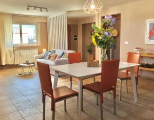 a living room with a dining table and chairs at Blue Apricot Apartment con Jacuzzi in Montesilvano