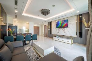 a living room with a large painting on the wall at THE LANDMARK 81 RESIDENCE LUXURY SUITE in Ho Chi Minh City