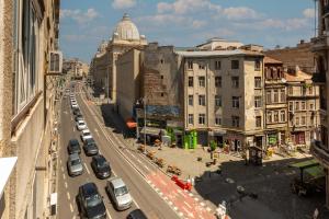 una strada cittadina trafficata con auto parcheggiate sulla strada di Modern 1BR Apt in the Old Town: The Perfect Choice a Bucarest