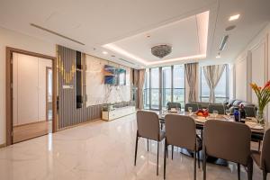 a dining room with a long table and chairs at THE LANDMARK 81 RESIDENCE LUXURY SUITE in Ho Chi Minh City