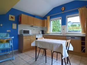 a kitchen with a table and chairs in a room at Luxury gite with sauna in Baugnez Malmedy in Arimont