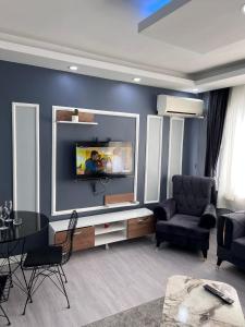 a living room with a tv on a wall at baran suites in Istanbul