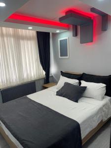 a bedroom with a large bed with a red ceiling at baran suites in Istanbul