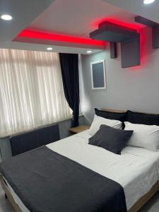 a bedroom with a large bed with a red beam at baran suites in Istanbul