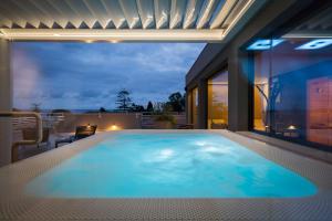 a large swimming pool on the balcony of a house at Corallo Wellness Hotel in Diano Marina