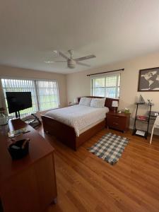 a bedroom with a bed and a television in it at Super Comfy " Arcade" Home in Cape Coral, Great Location! in Cape Coral