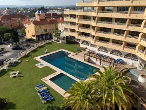 an aerial view of a large apartment building with a swimming pool at Discovery Apartment Vilamoura in Vilamoura