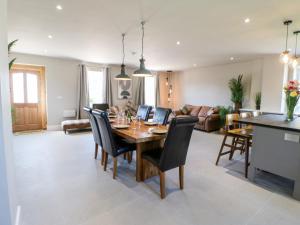 a dining room and living room with a table and chairs at The Workshop in Northallerton