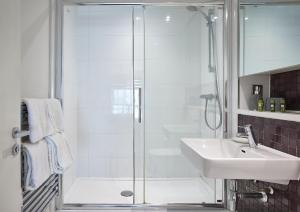 a bathroom with a shower and a sink at The Glassworks by Ritual Stays in Hemel Hempstead