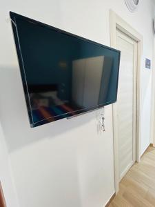 a flat screen tv hanging on a wall at SicilyHouse Palermo in Palermo